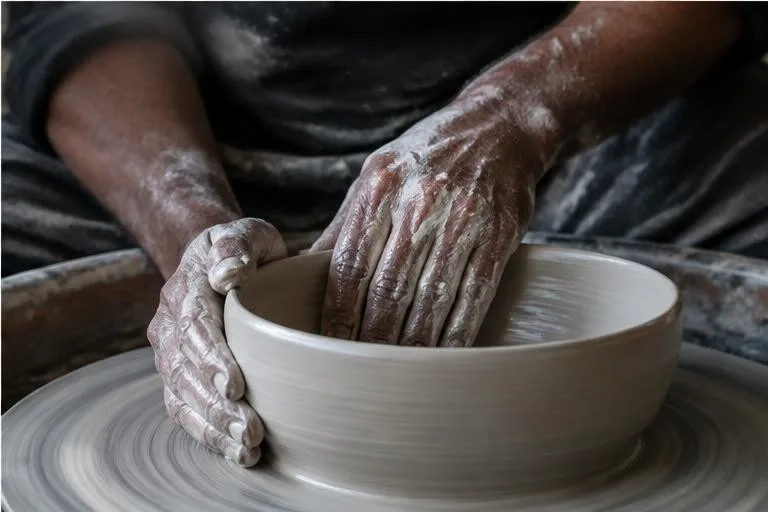 Representative image: hands shaping clay on a pottery wheel